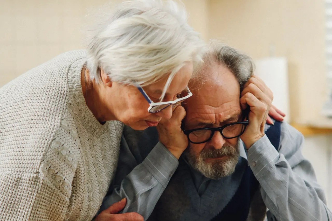 An older couple looking at documents at a table
