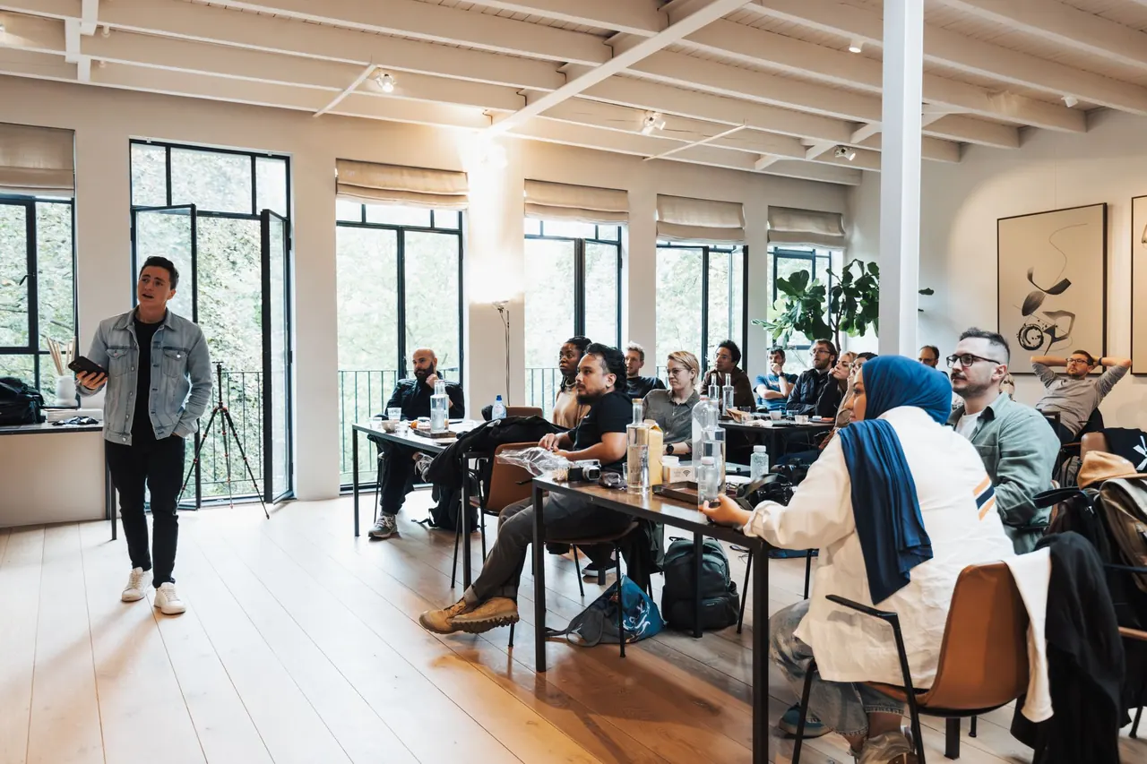 A training course in a bright room with long tables